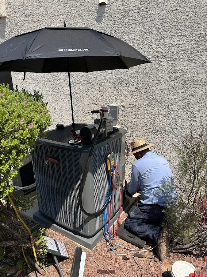 HVAC technician performing outdoor AC maintenance in Torrance