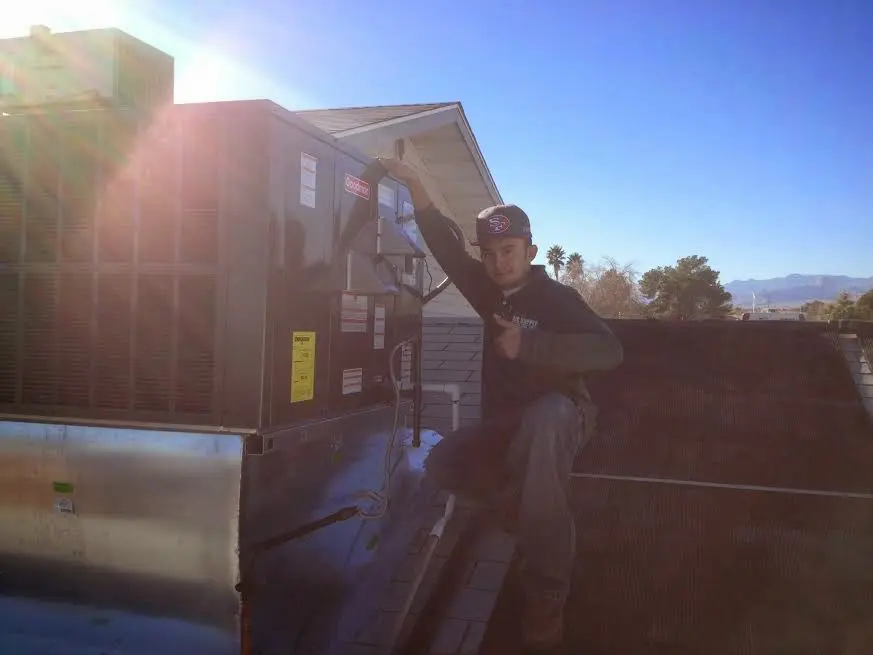 HVAC technician performing AC Tune-Up on a rooftop unit in Torrance